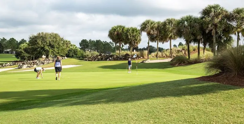 three women playing golf